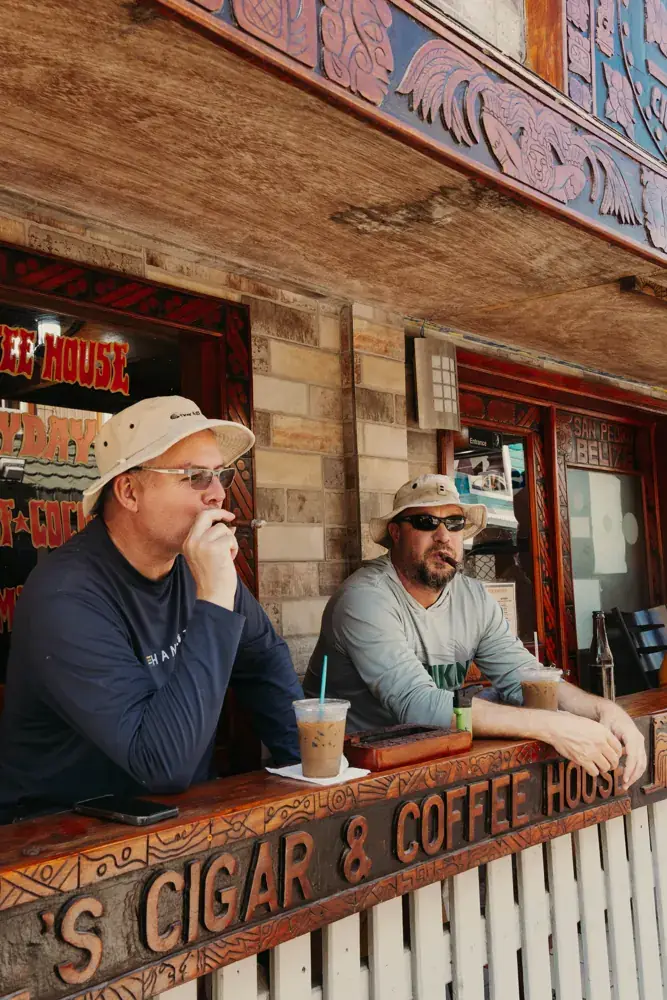 Two guests with coffee at the counter on the front porch