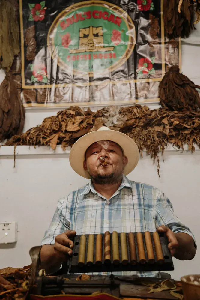 The roller holding a press of freshly rolled cigars